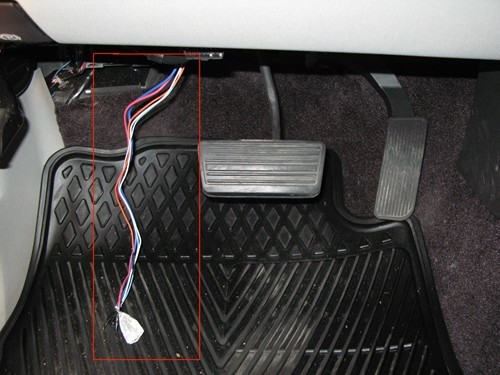 Tow package wires pulled beneath steering column