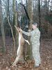 Man skinning deer hung on Viking Solutions Kwik Hoist.