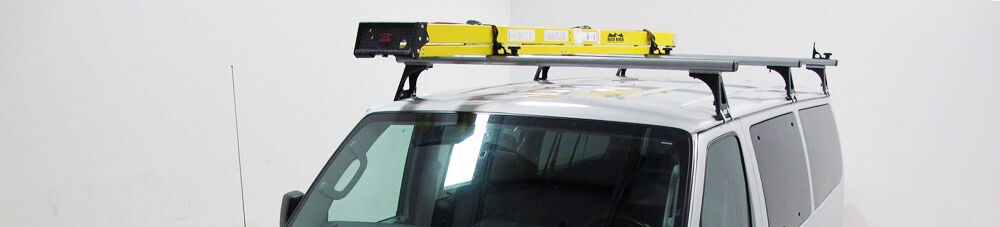 Cargo van with yellow ladder mounted on van ladder rack.