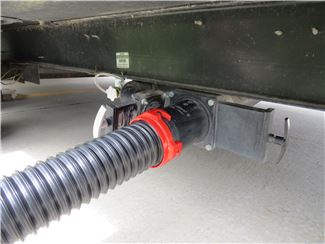 Sewer Hose Attached to RV Waste Station