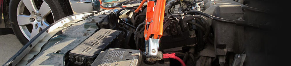 Jumper cable attached to car battery.