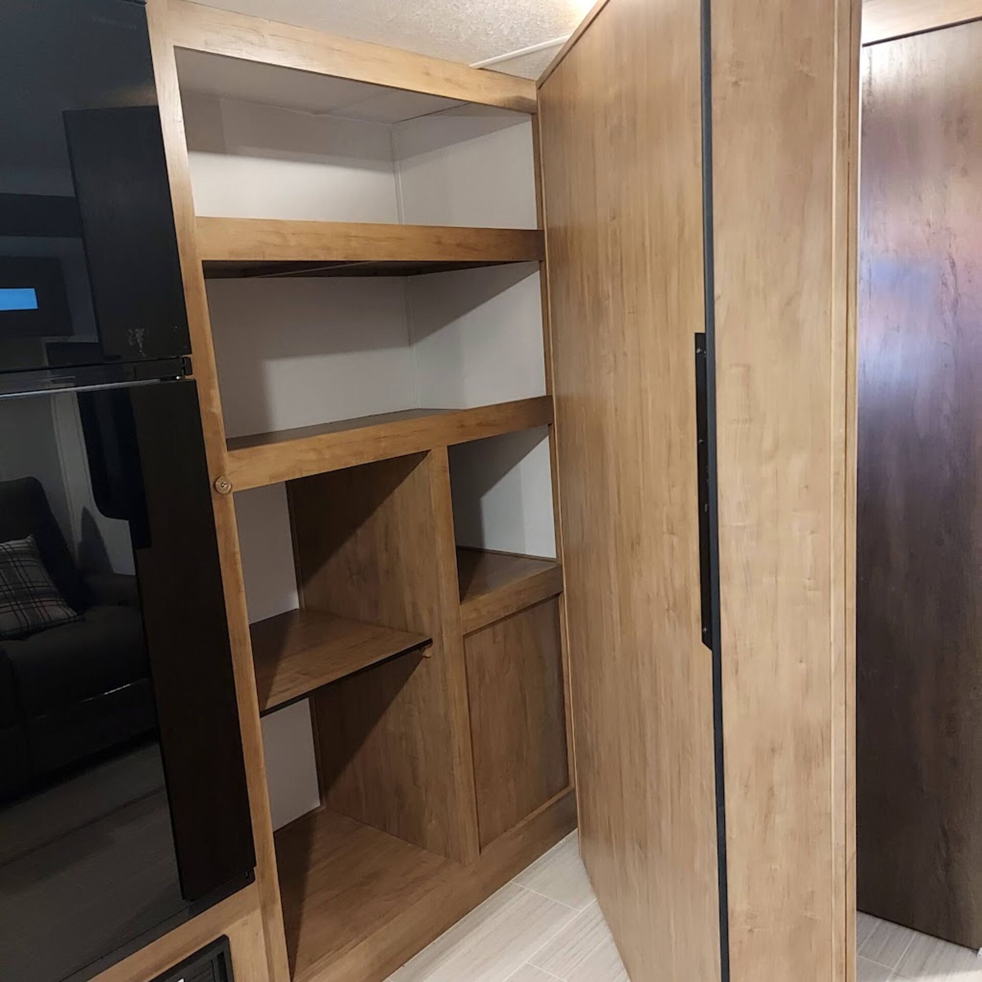 Additional cabinet storage behind panel 
