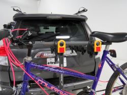 Bicycle with adapter bar mounted on trunk-mounted bicycle carrier