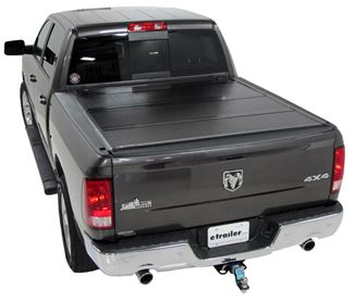 Tonneau cover installed on black pickup truck