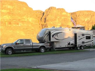 Truck Towing Fifth Wheel Near Mountains