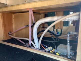 Pink RV pipes filled with antifreeze