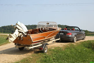 Car towing boat trailer