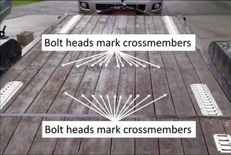 Bolt heads marking crossbars on flatbed trailer