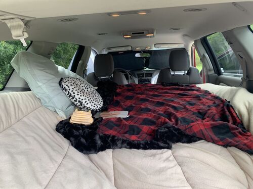 Sleeping bag and bedding inside Chevy Traverse