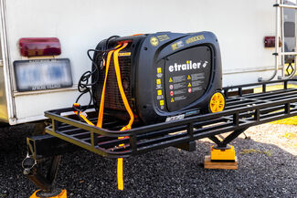 Portable generator on back of RV cargo tray