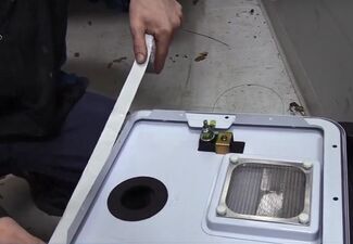 Applying Butyl Tape to Water Heater Door