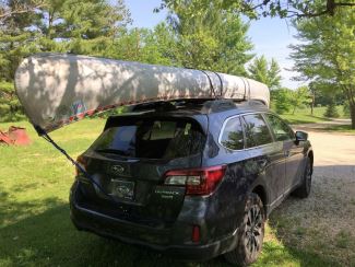 Canoe strapped to vehicle roof