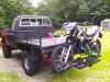 Motorcycle carried on the back of truck on motorcycle carriers.