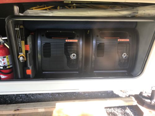 Image of two portable generators installed in an RV's external compartment