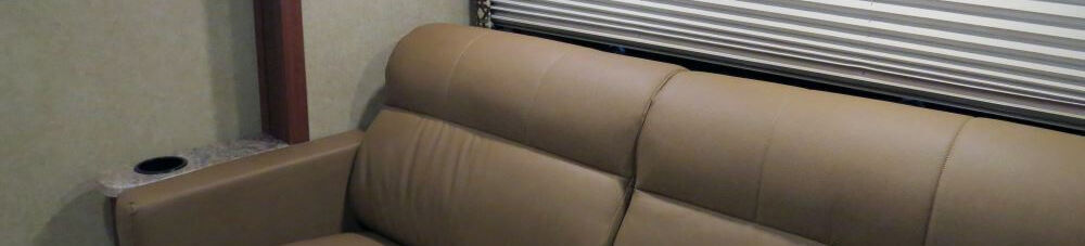 Thomas Payne tan leather couch in RV living room.