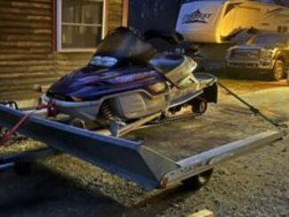 snowmobile on trailer at night. 