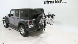 Thule hitch-mounted bicycle carrier installed on Jeep Wrangler with bike loaded