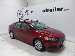 Thule roof-mounted bicycle carrier on sedan with bike
