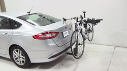 Thule hitch-mounted bicycle carrier on sedan with bike