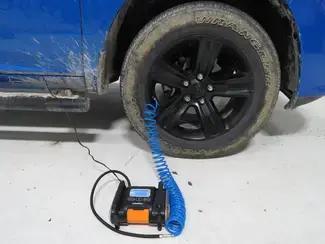 Portable Air Compressor Airing Up Tire