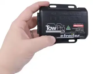 Hand holding Tow Pro brake controller unit.
