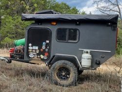 Gray off road trailer loaded with gear.